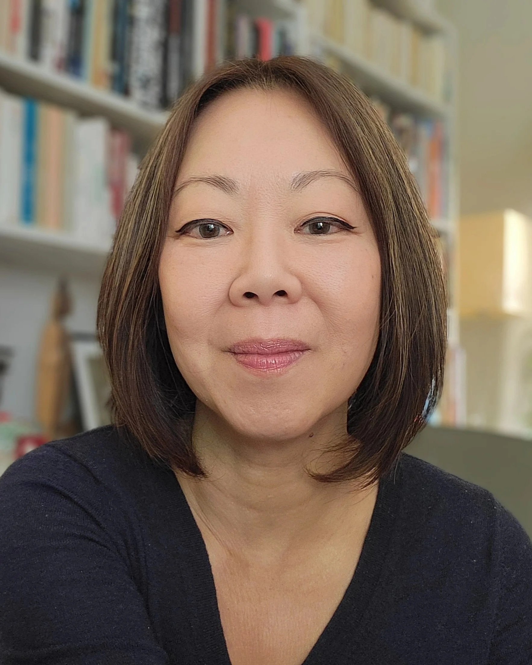 Dr. Wendy C. Ong, clinical psychologist, seated in front of a bookshelf.