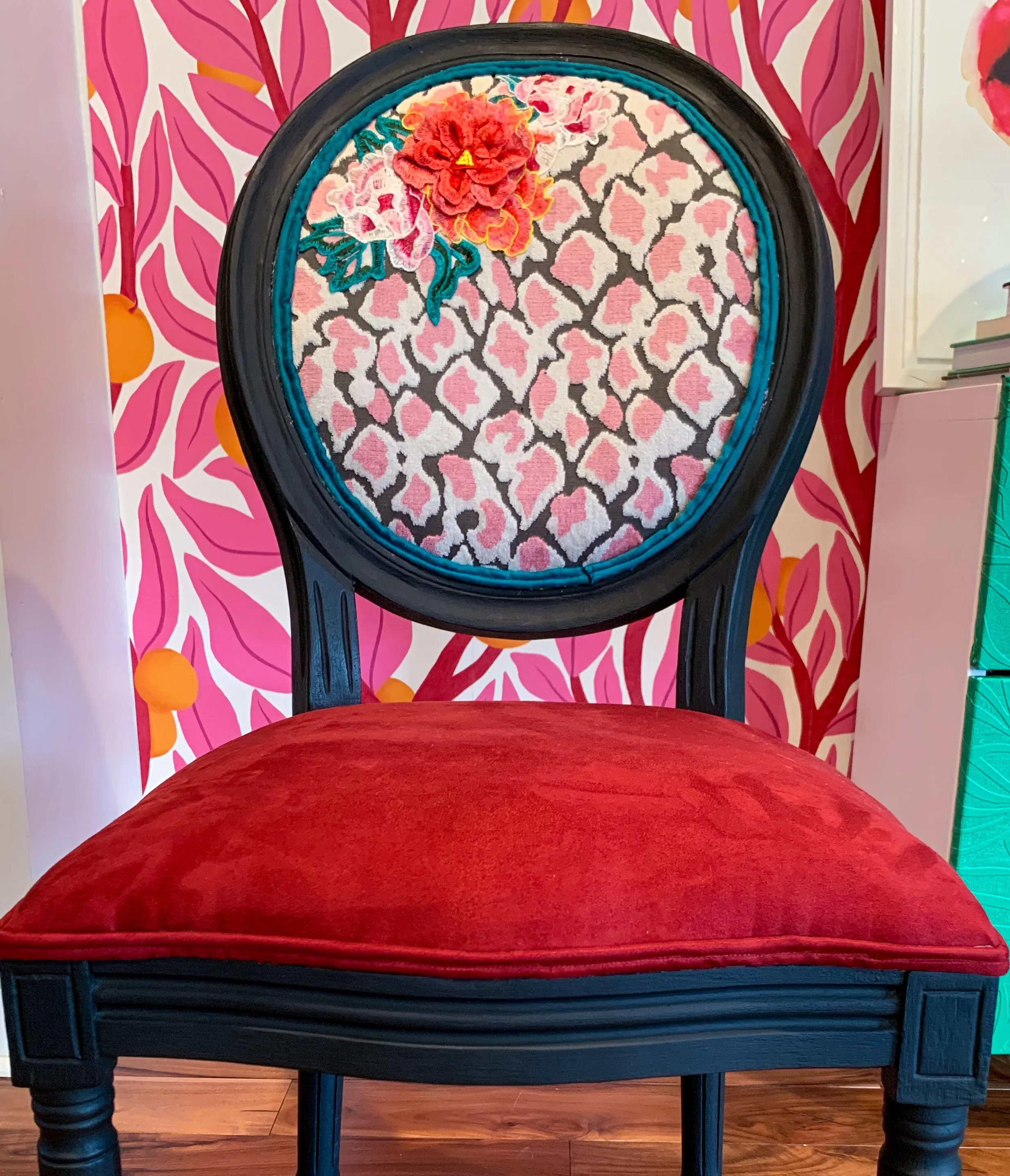 Custom reupholstered vintage chair with bold red velvet seat and patterned back in a maximalist interior designed by Melissa B. Rodgers