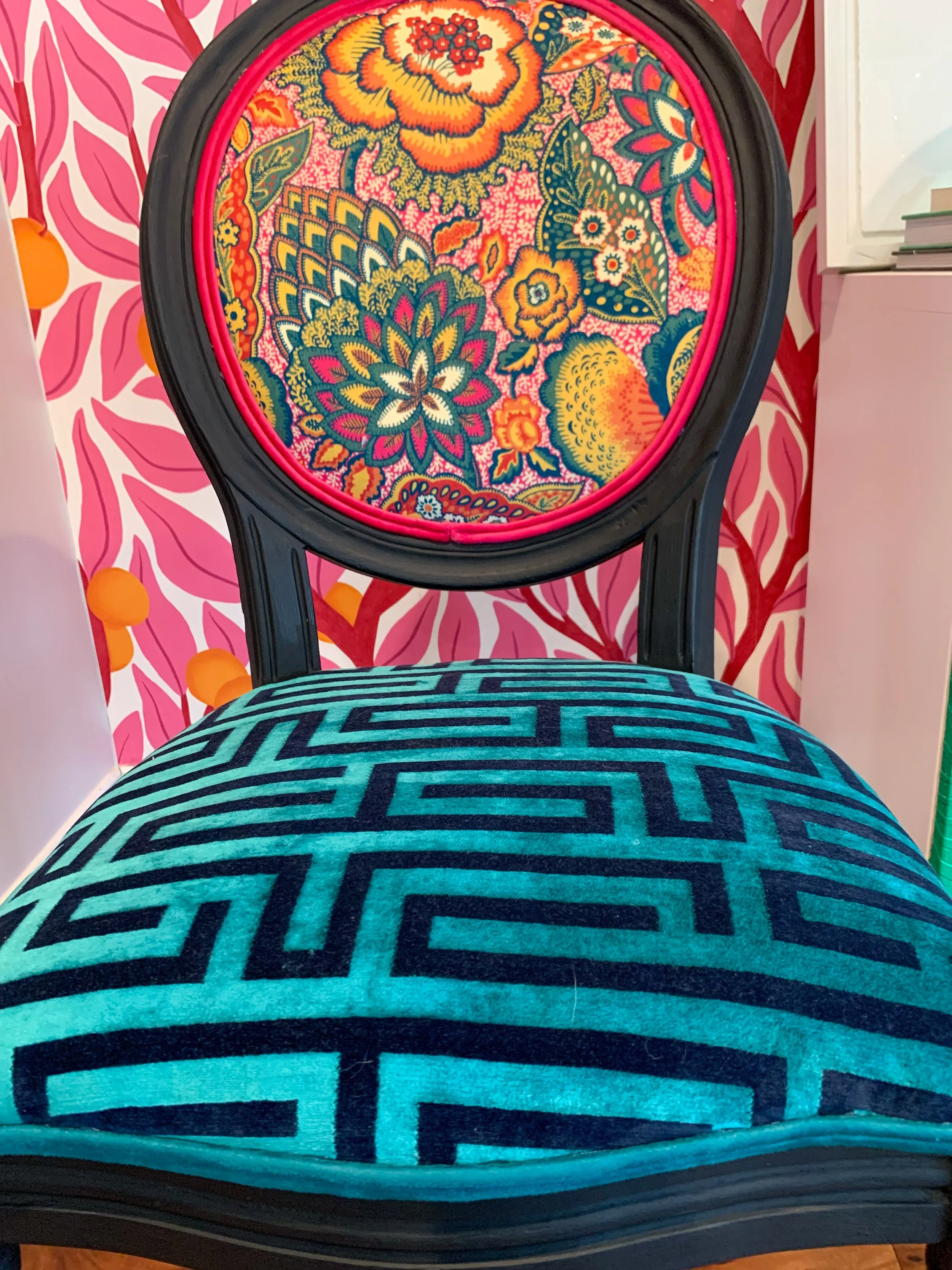 Custom upholstered teal geometric chair with bold patterned fabric in eclectic interior design project designed by Melissa B Rodgers