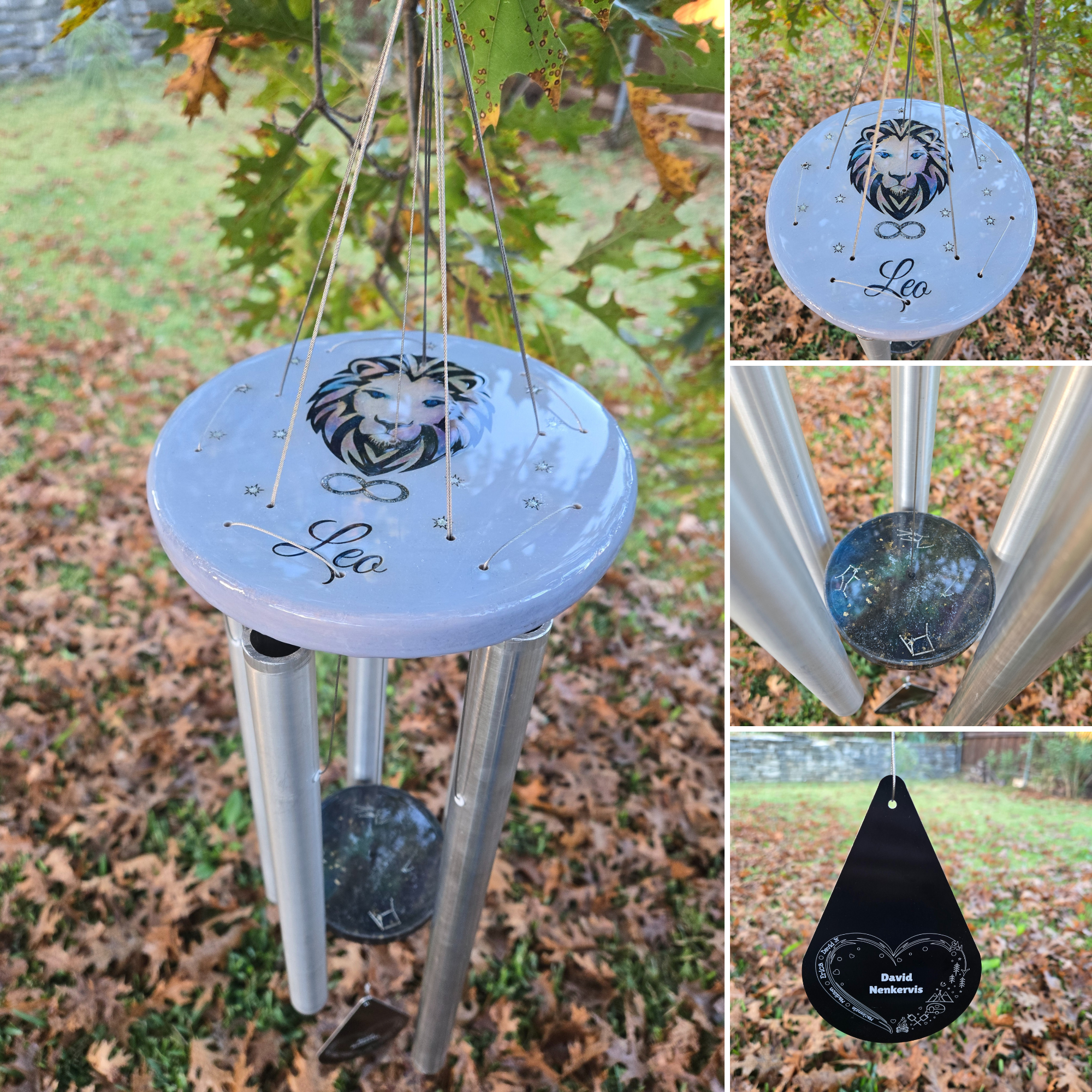 A wind chime with a circular top featuring a lion's head, the word 'Leo', and decorative stars, hanging from tree branches in an autumn setting. The bottom has a shiny, black circular weight with zodiac signs and a name engraved, connected by metal t