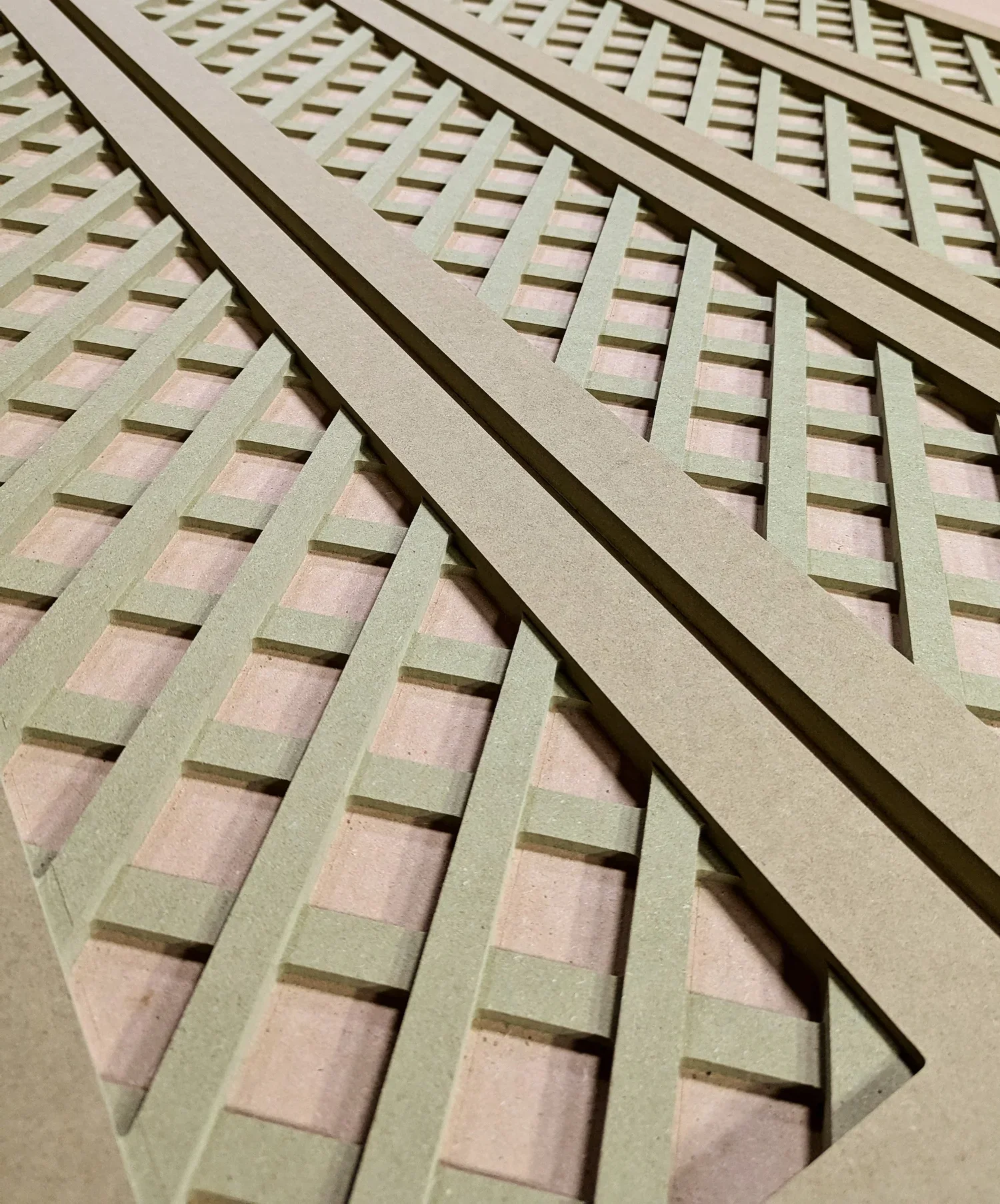 Close-up of intertwined beige wooden slats arranged in a grid pattern.