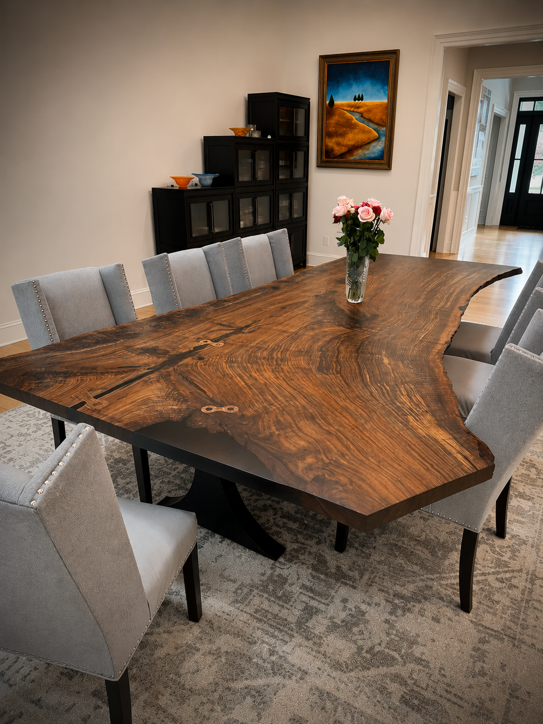 Claro walnut coffee table with a single-piece waterfall grain, styled with a small potted plant