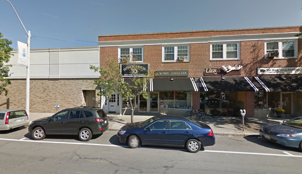 Street view of Diana Phillips’ Rolfing Structural Integration office located in a downtown brick building with local shops.