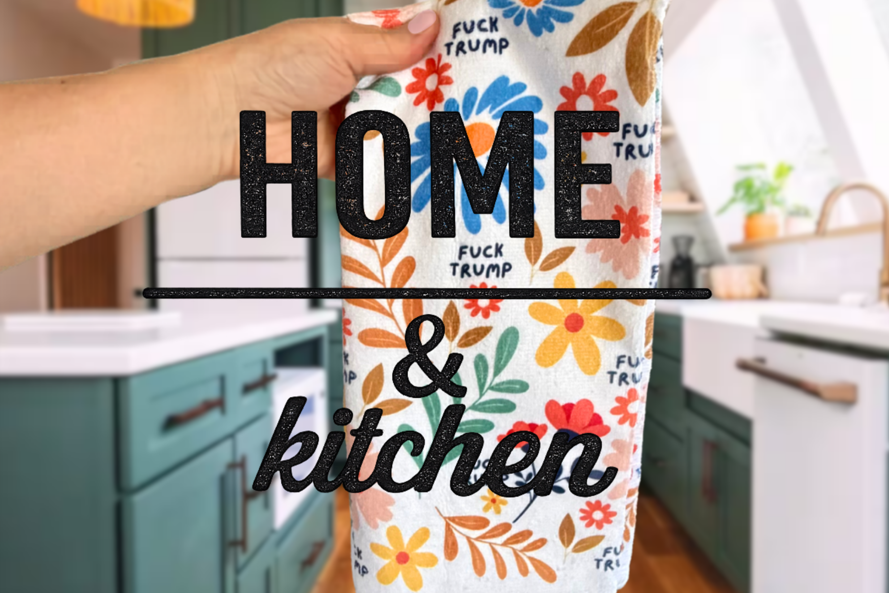 A kitchen with teal cabinets and a white countertop, showing a dish towel with colorful flowers and the words 'FUCK TRUMP' repeated on it, hanging in the foreground.