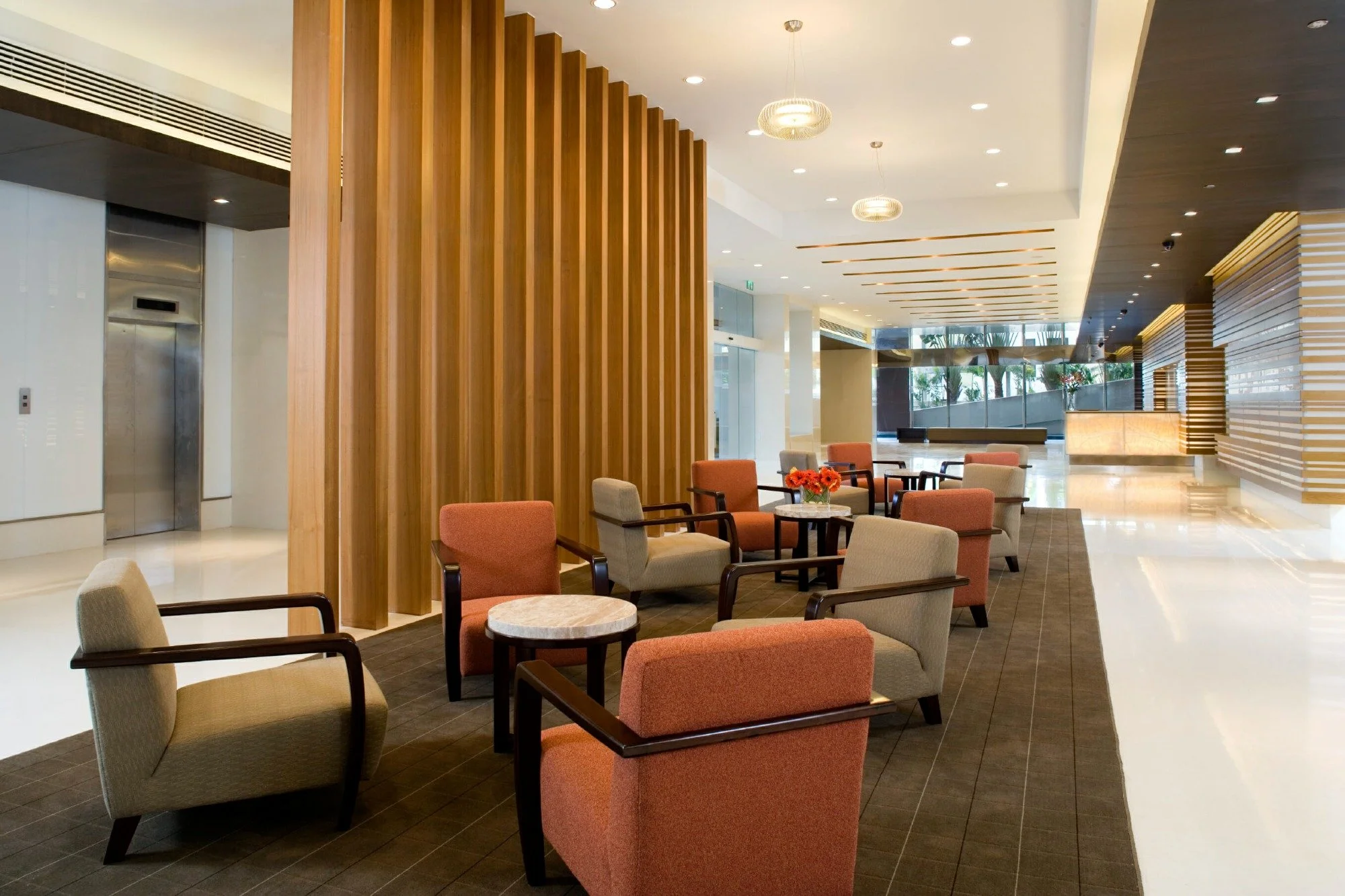 Modern apartment community lobby in Columbus, Ohio with seating area, wooden wall panels, and large windows with natural light