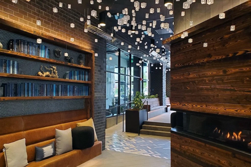 Interior of a modern apartment community lobby featuring a cozy leather seating area that was recently cleaned in Columbus, Ohio