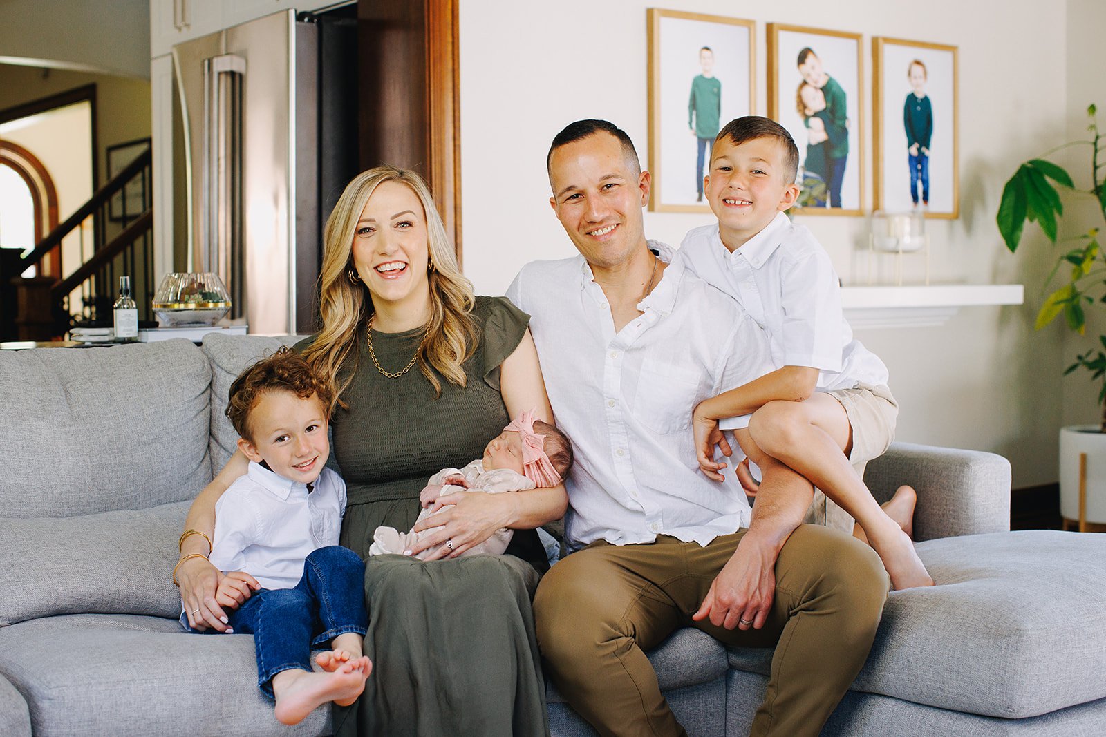 The owners of Columbus Cleaning Service, Isaac and Jenna, sitting with their three children