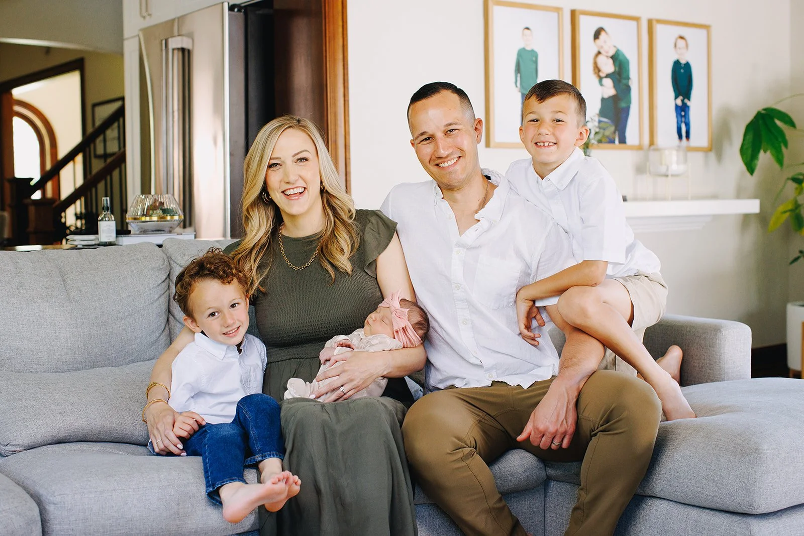 The owners of Columbus Cleaning Service, Isaac and Jenna, sitting with their three children