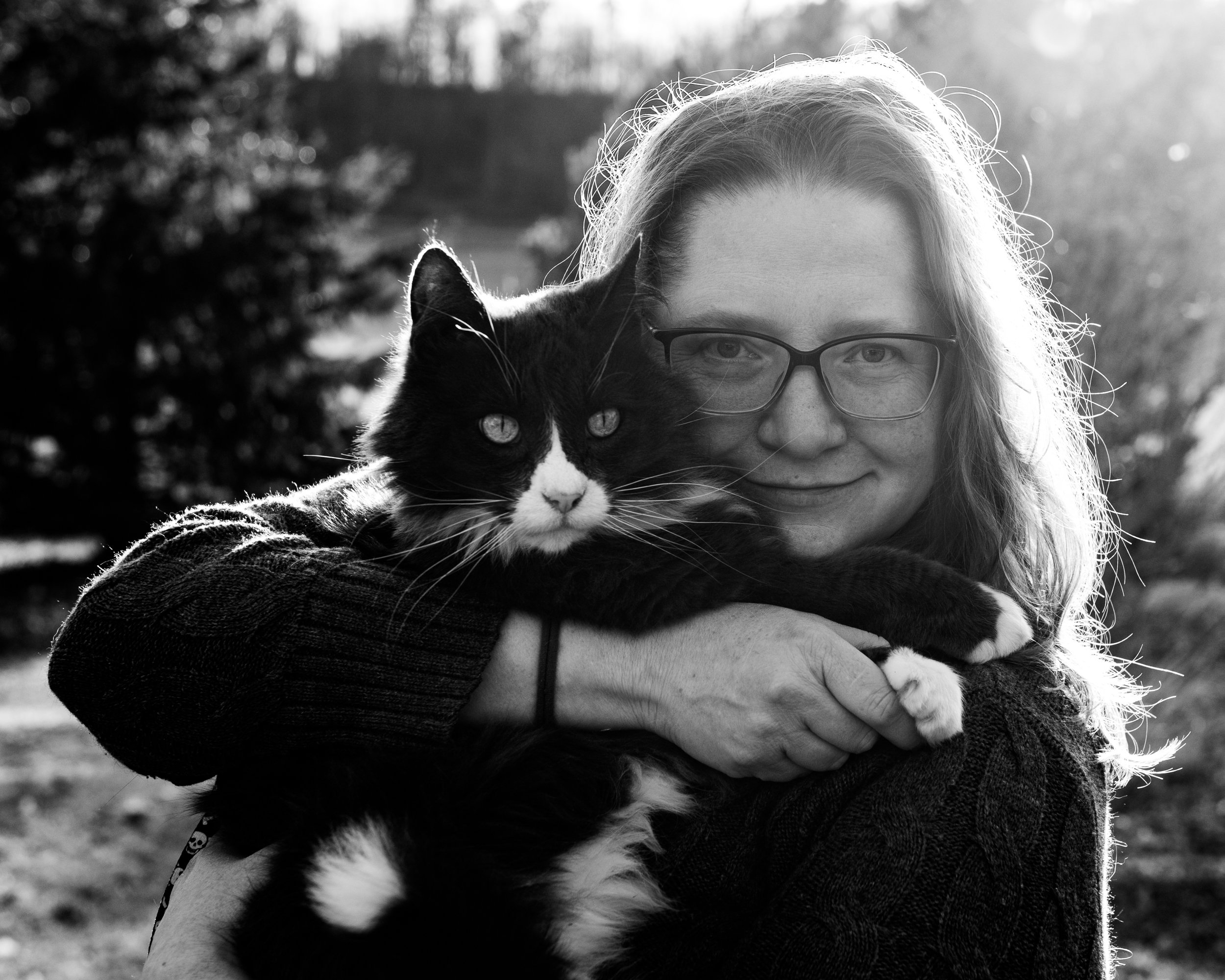 Outdoor photo portrait of woman and pet cat in Menomonie with natural sun light in background