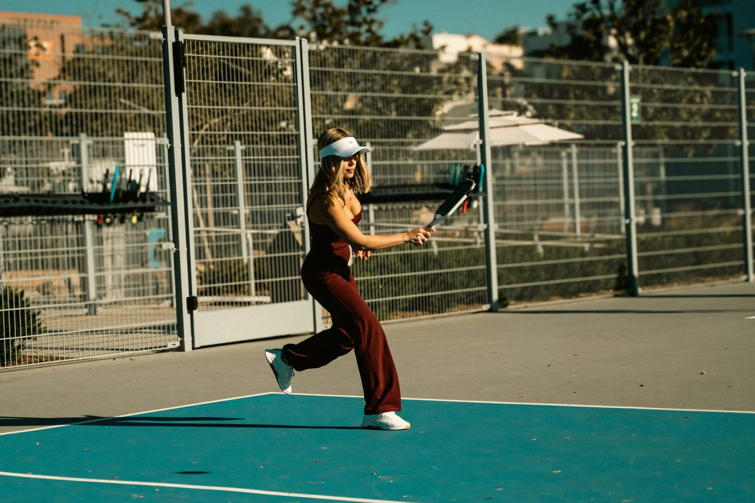 Female pickleball player in action.