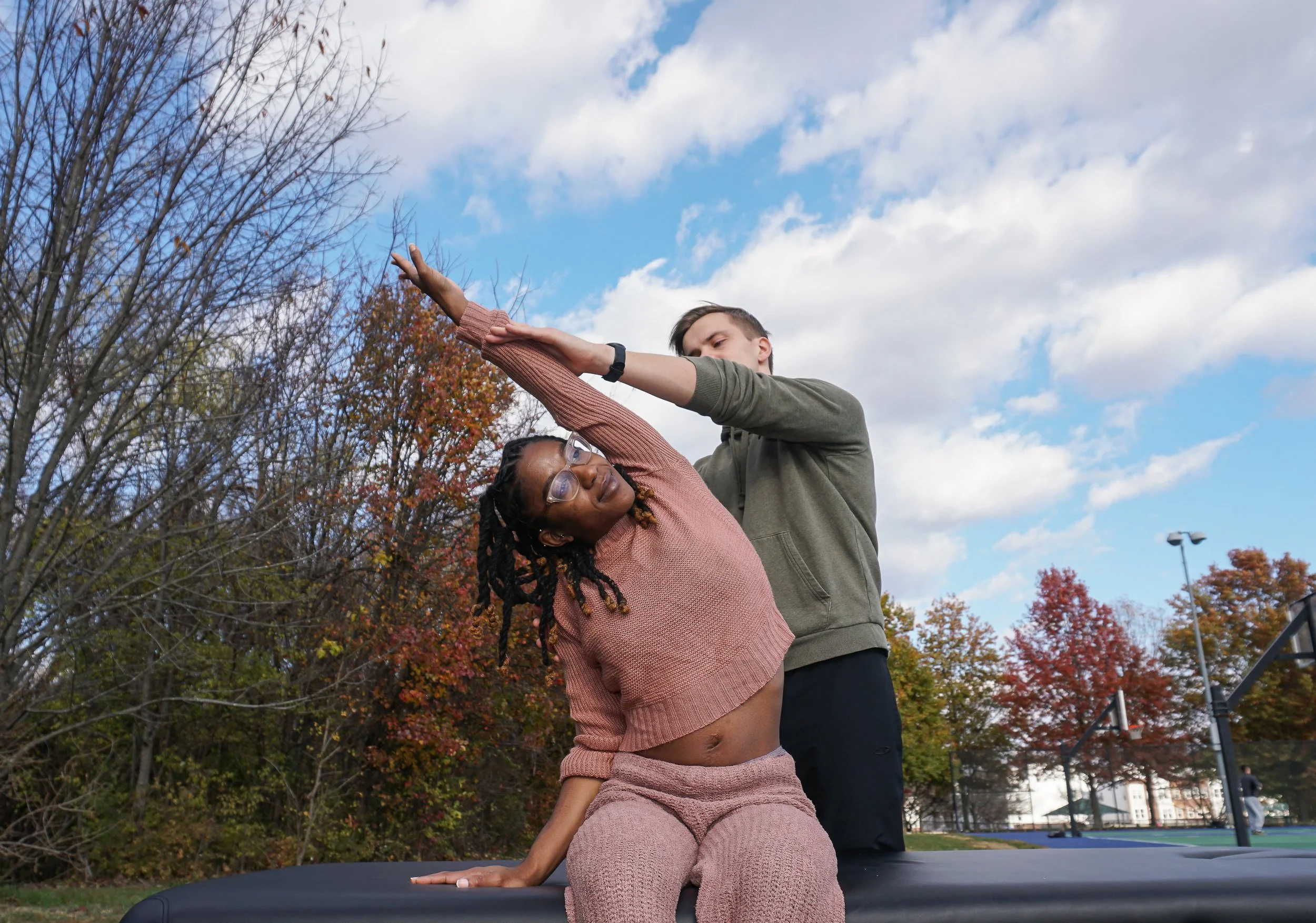Assisted stretch performed by Jamie Harmon.
