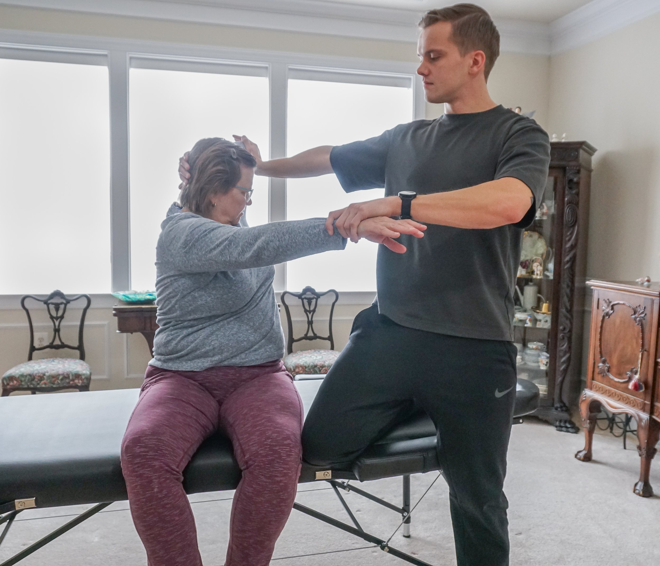 Assisted back stretches for female at home.