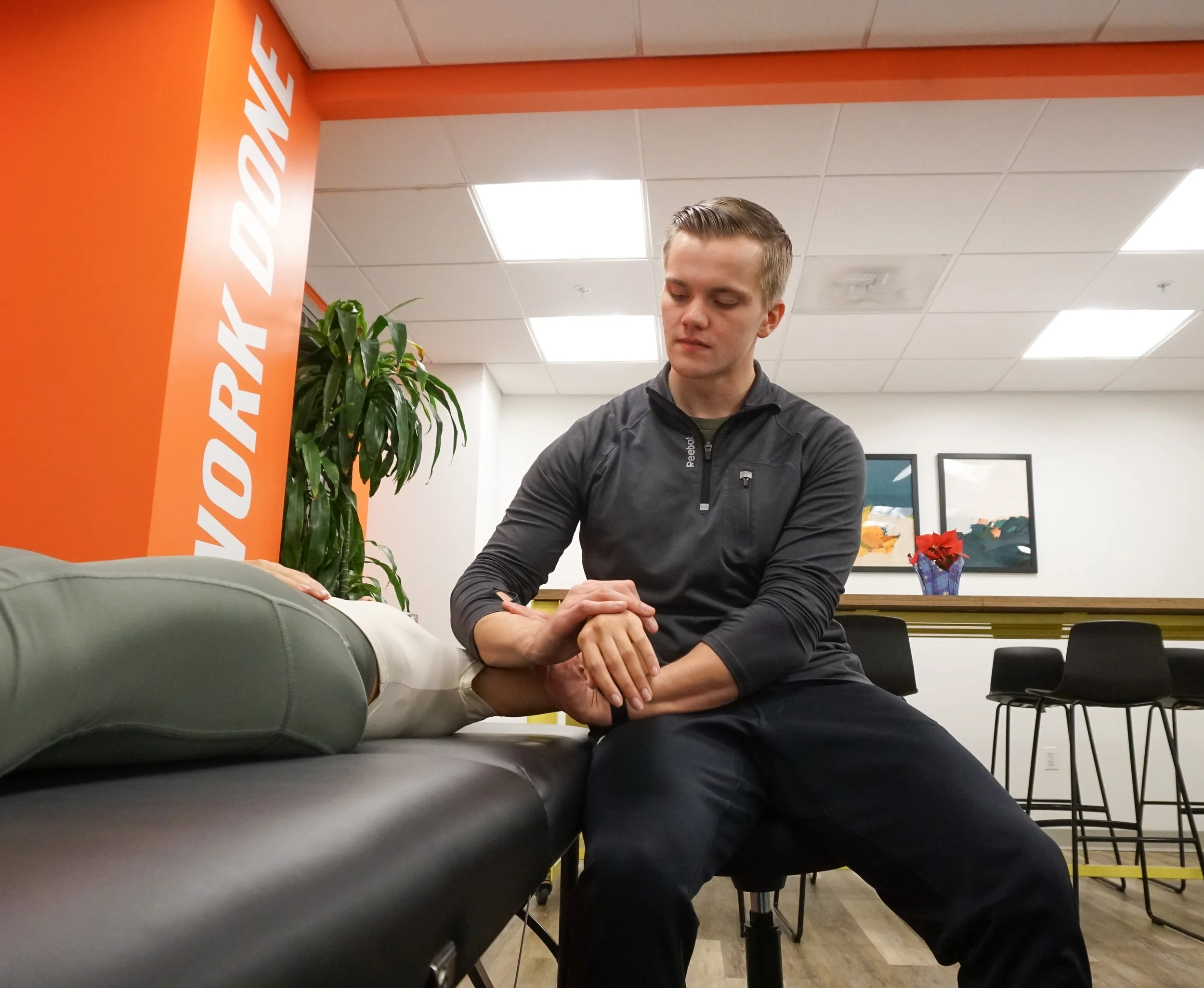 Assisted stretching therapist helping client improve flexibility at Austin stretching studio.