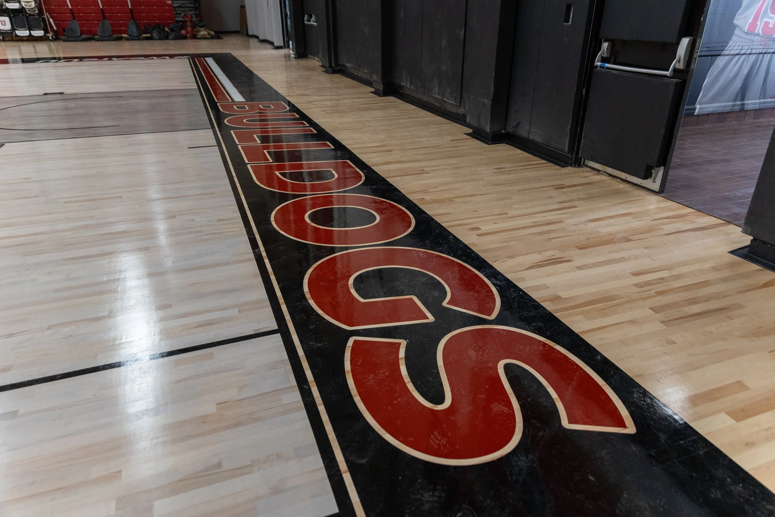 Basketball court with a black border featuring the word 'SOULCO' in red and white lettering.