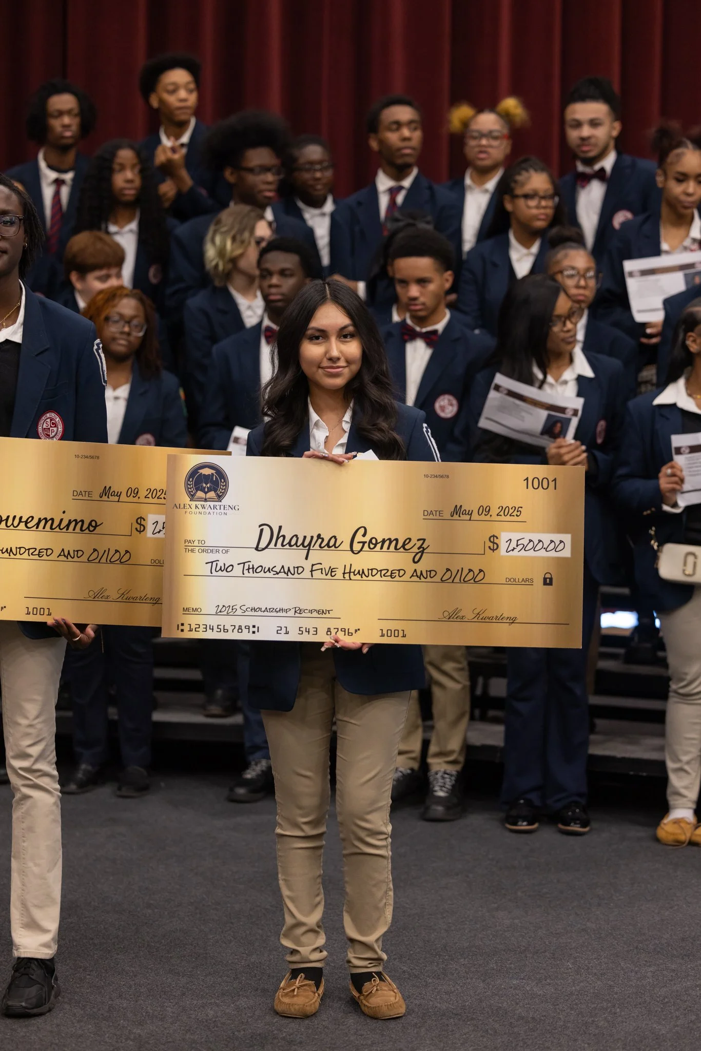 Alex Kwarteng Foundation scholarship recipient at Southland College Prep holding a merit-based award check for academic excellence.