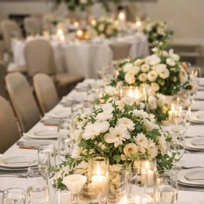 Elegant private event table setup with floral centerpieces and formal place settings for celebrations.