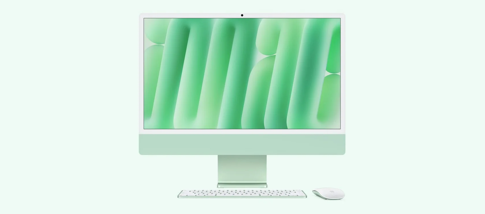 Computer desktop con monitor, tastiera e mouse, tutti di colore bianco, in un ambiente luminoso e minimalista.