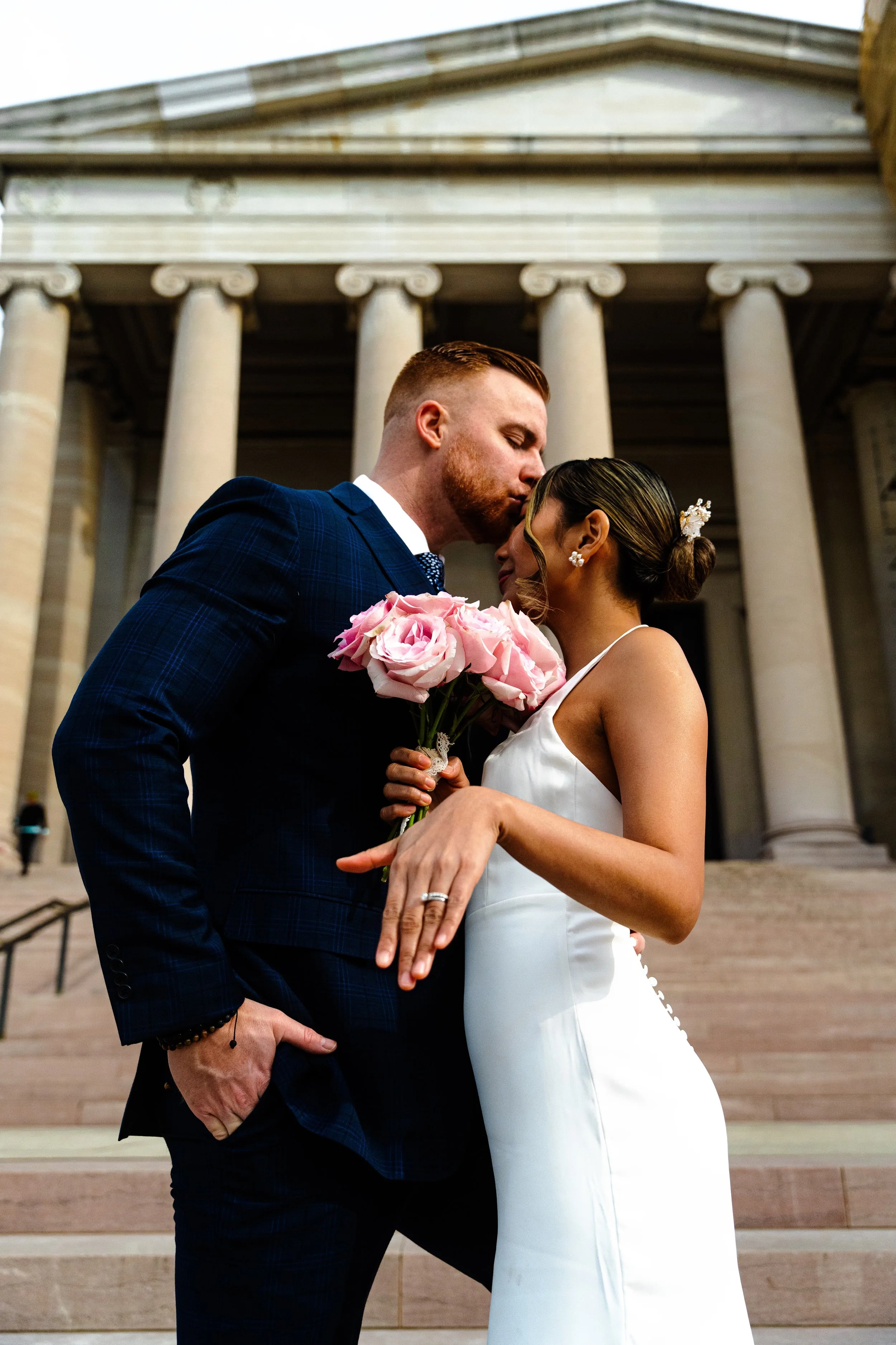 Laurie’s customers, Fernando and Kate embracing by the lake on their wedding day.