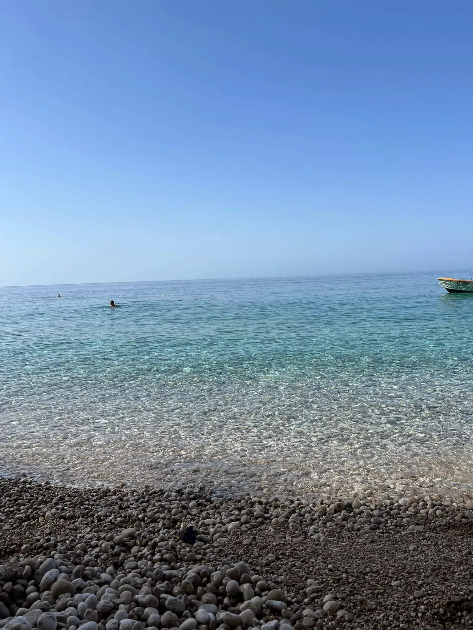 Crystal clear Adriatic sea and pebble beach view from a Local Boats Cavtat tour.