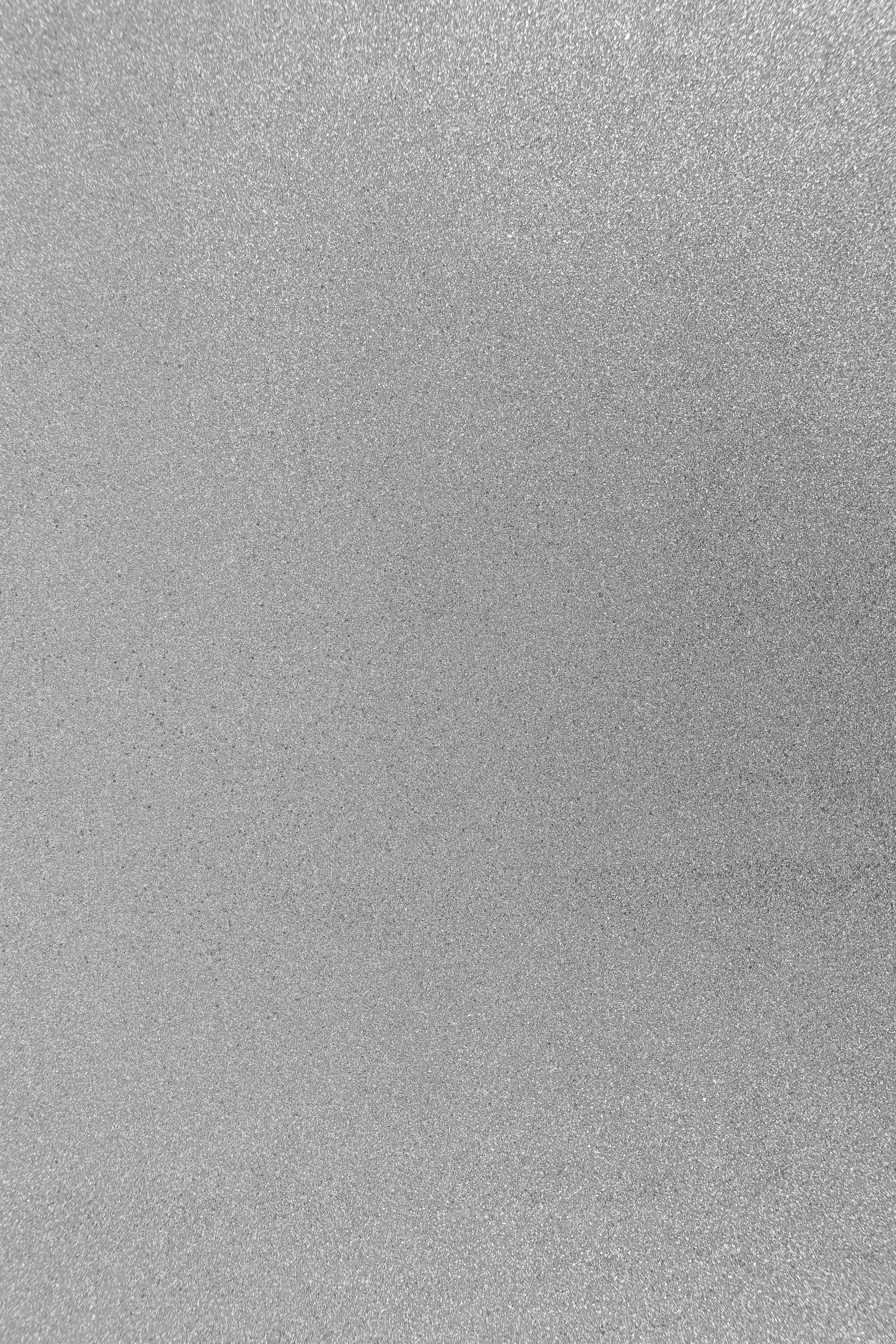 Close-up of metallic silver, glittery, textured surface.