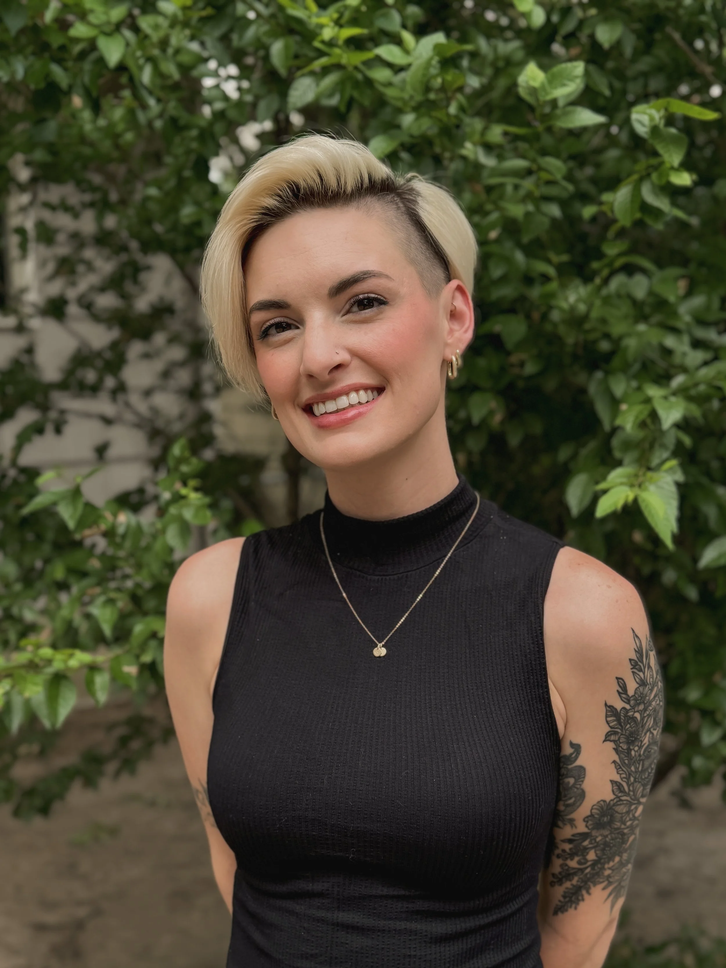 Jade Kiyak, a commissioned mobile notary public in Colorado Springs, standing outdoors and smiling.