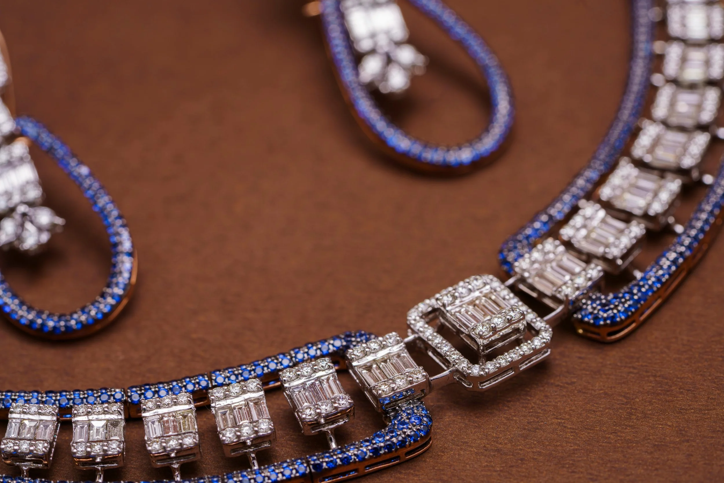 Jewelry set including a necklace and bracelet with blue and white gemstones