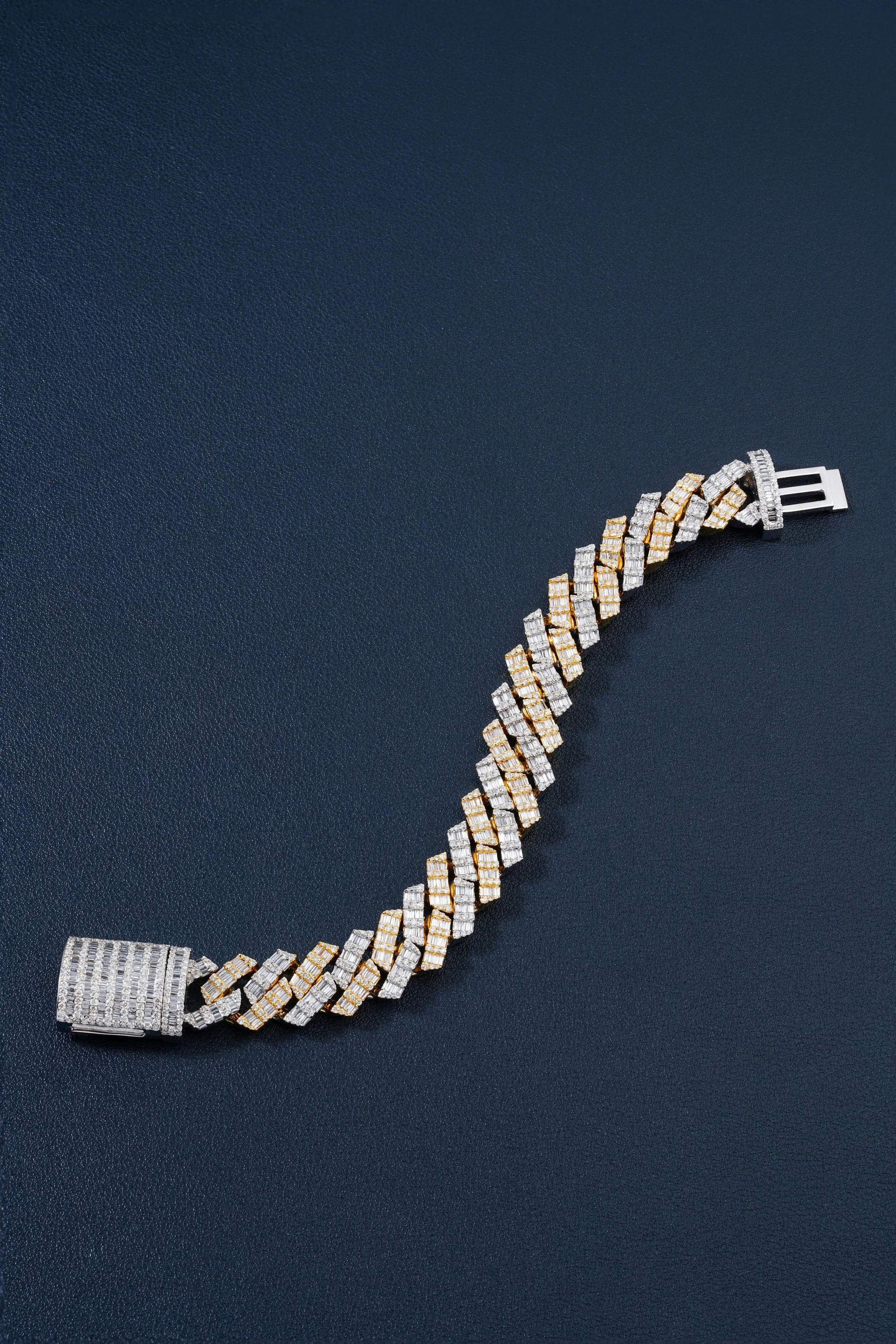 A diamond and gold bracelet on a dark background.