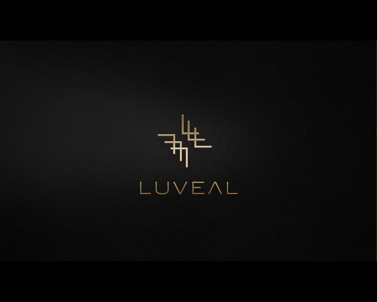 Black background with gold geometric logo and the word LUVEAL in gold text.