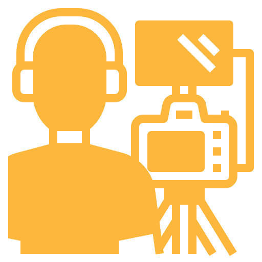 Icon of a person wearing headphones operating a video camera on a tripod.