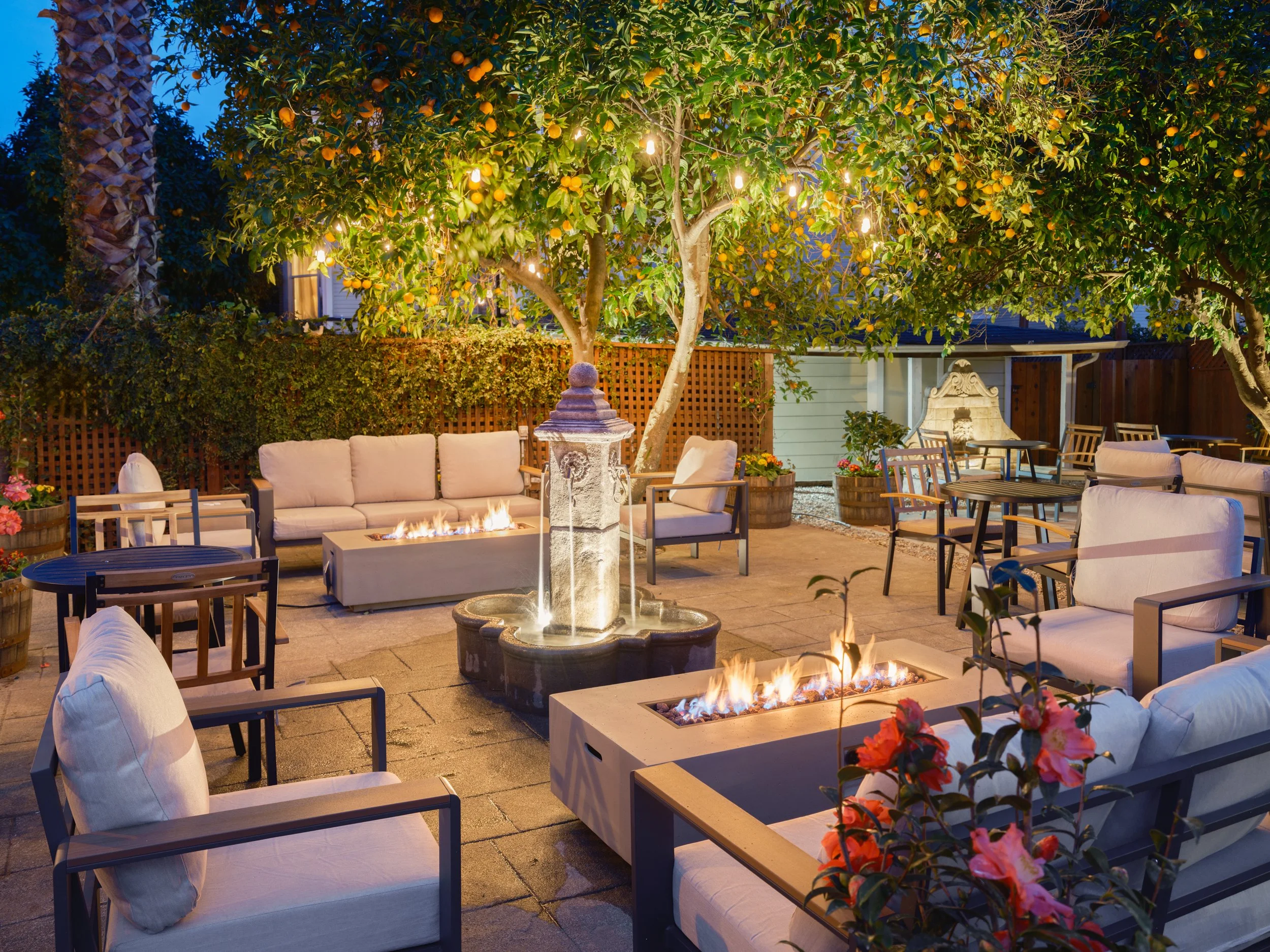 The courtyard comes alive at night with the radiant glow of spotlights and the warm flickering light of fire pits.