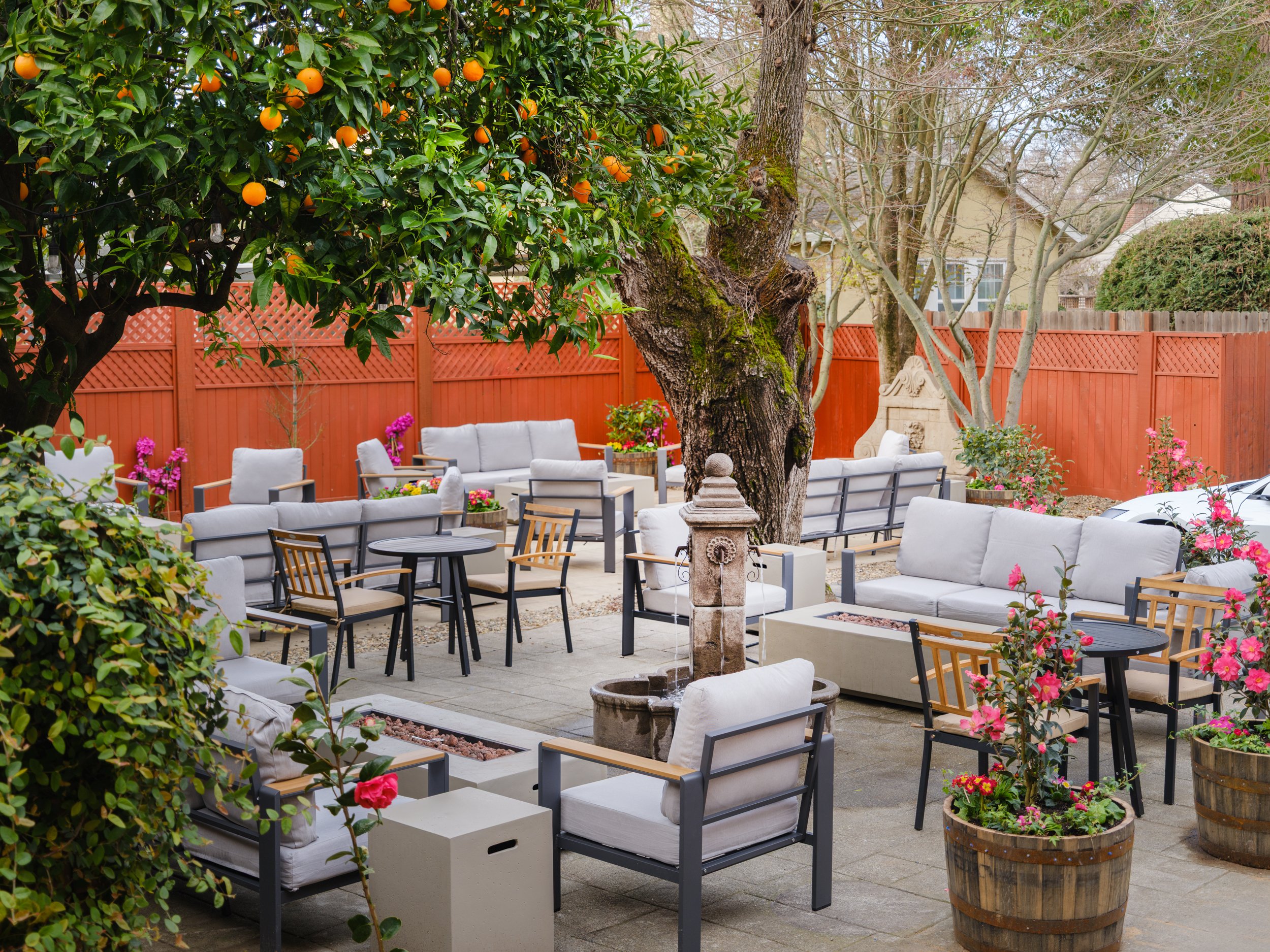 The expansive outdoor courtyard beckons with comfortable lounge seating and the relaxing sound of bubbling water fountains.