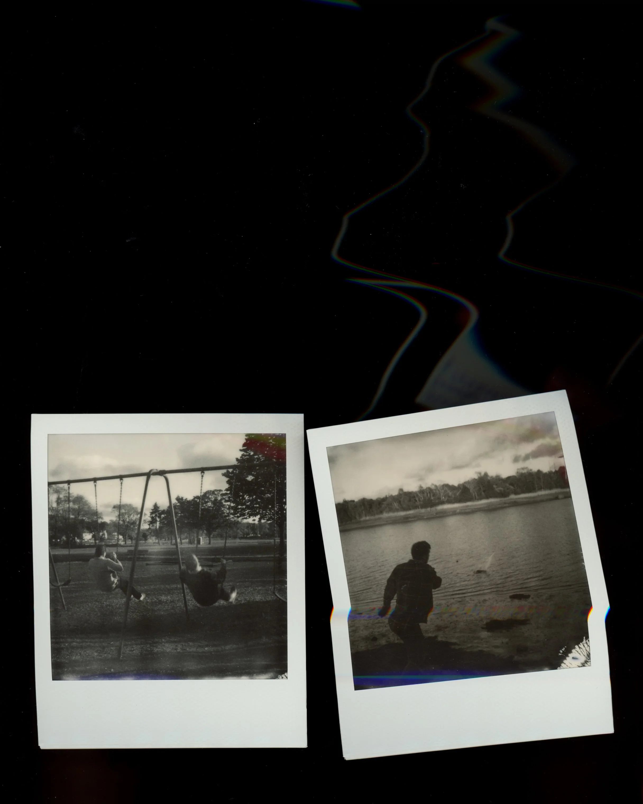 Two black and white Polaroid photos on a dark surface with a colorful, distorted profile of a person's face in the background. The left photo shows two children on swings at a playground, and the right photo depicts a person fishing by a body of wate