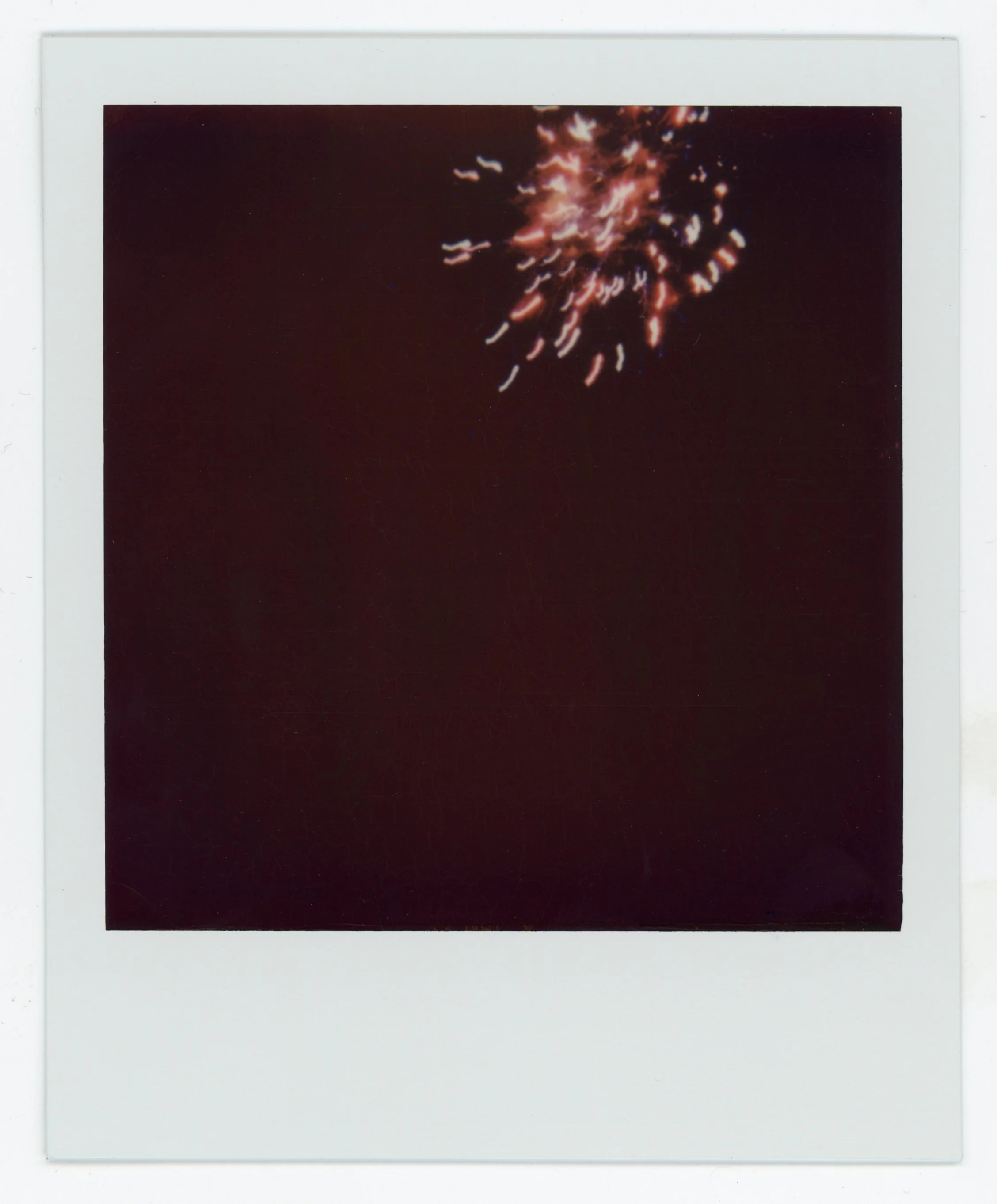 A fireworks explosion in the night sky with bright sparks.