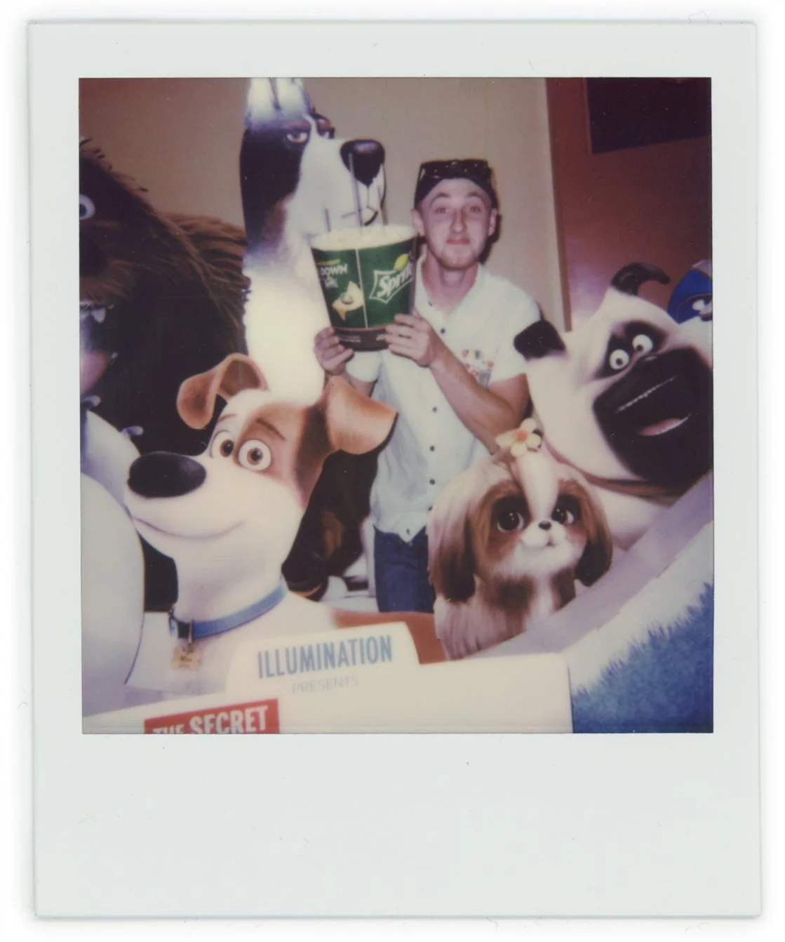 A man holding a bucket with a dog cartoon face, surrounded by four people with dog costumes and masks.