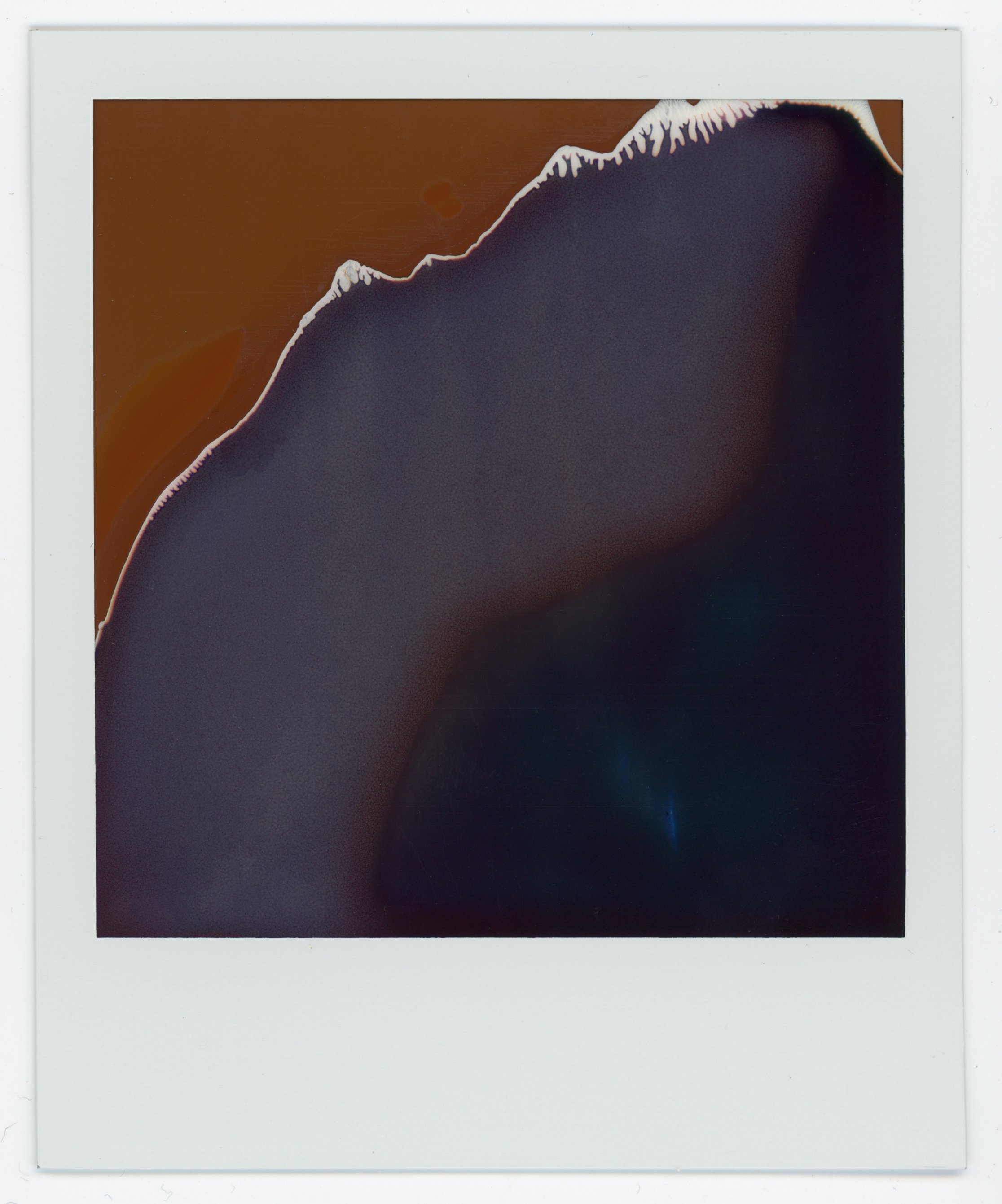 An abstract image with a dark shape outlined in white and a background with reddish and dark hues.