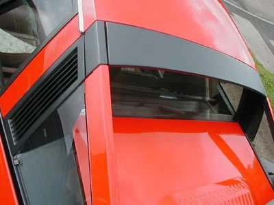 Top view of a red vehicle, focusing on the roof and rear window.  Technical Composites.