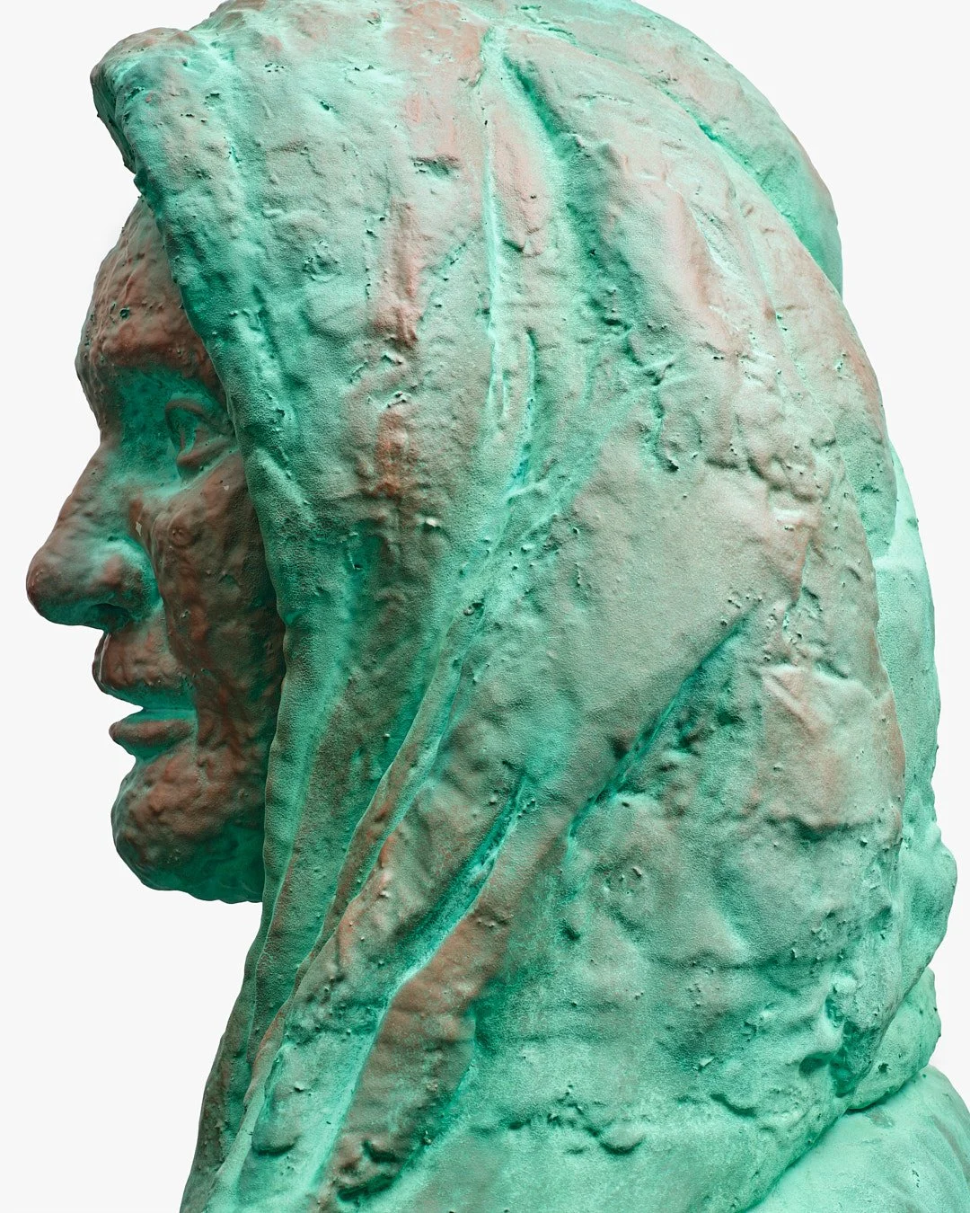 Close-up of a greenish bronze bust of a man with long hair, shown in profile.
