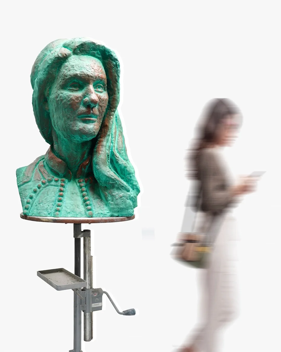 A bronze bust sculpture of a woman wearing a dress with a collar and decorative buttons, mounted on an adjustable stand, with a woman using a smartphone blurred in the background on a white backdrop.