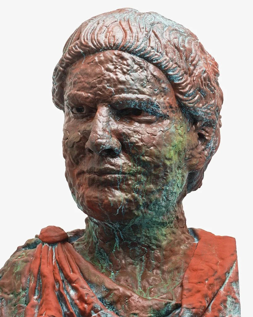 Close-up of a weathered, bronze sculpture bust of a woman with detailed facial features and textured hair, with green and blue patina accents.