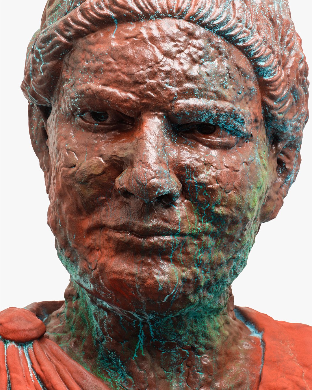 Close-up of a textured bronze or copper bust of a man with a serious expression, with green and blue paint splatters, resembling an ancient artifact or modern art sculpture.