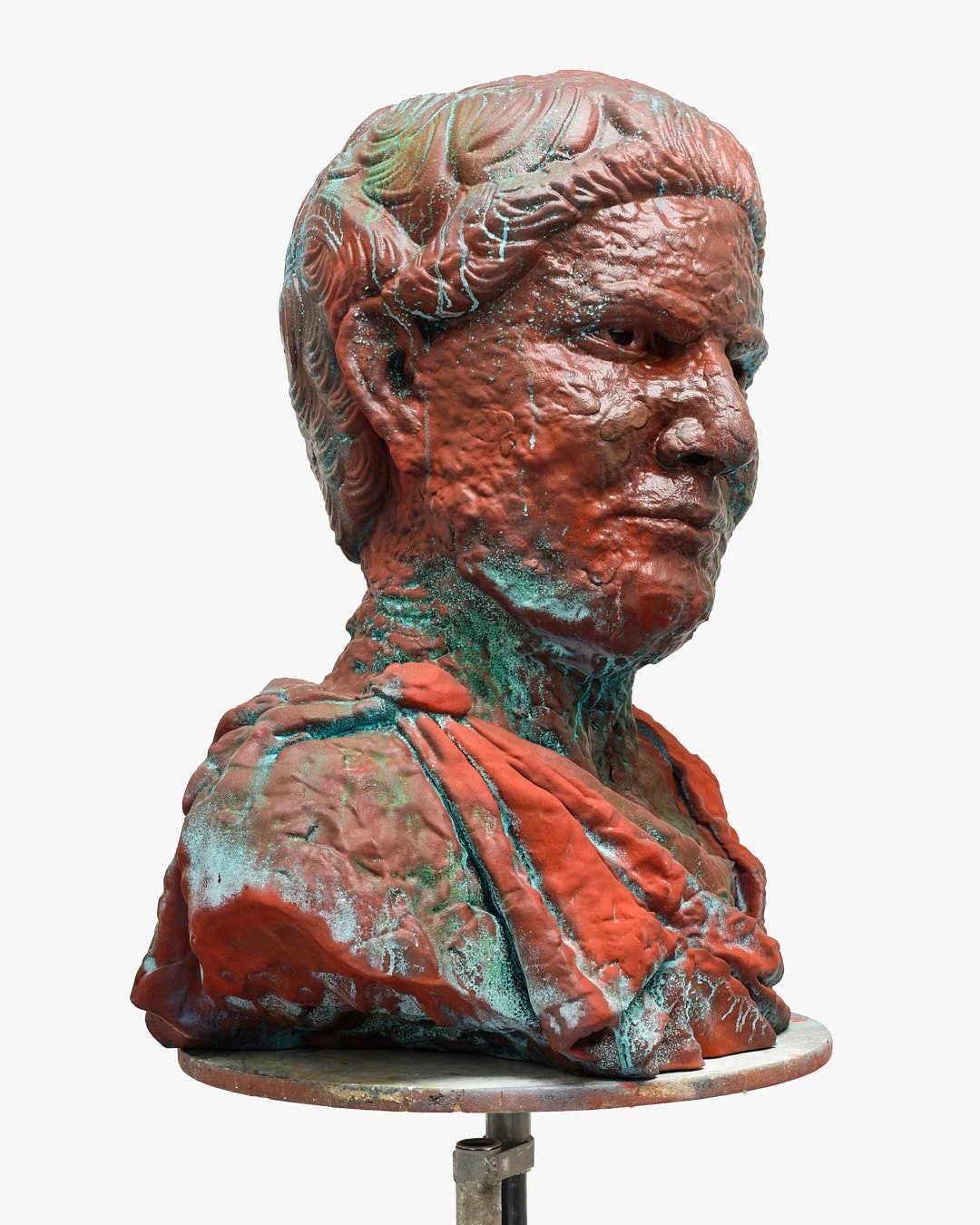 Bronze bust sculpture of a woman with detailed hair and clothing, exhibiting a weathered patina with greenish deposits.