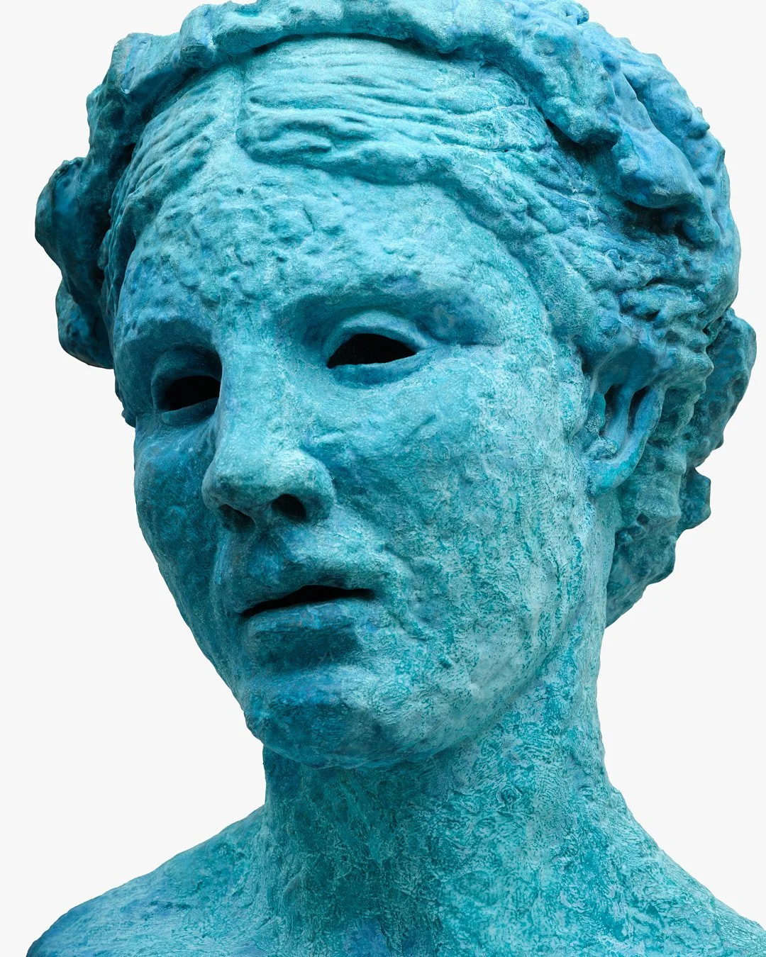 A large blue sculpture of a woman's face with a serious expression, detailed hair, and hollow eyes.