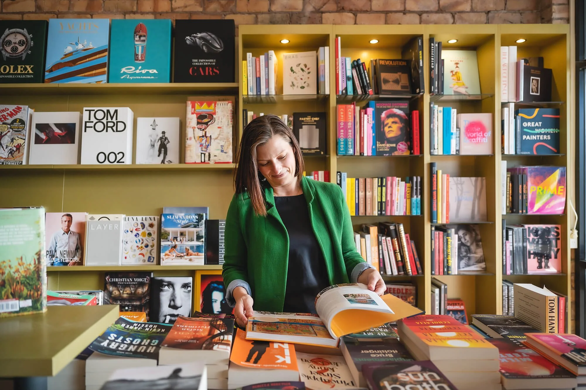 Meditation teacher in bookstore, with book open
