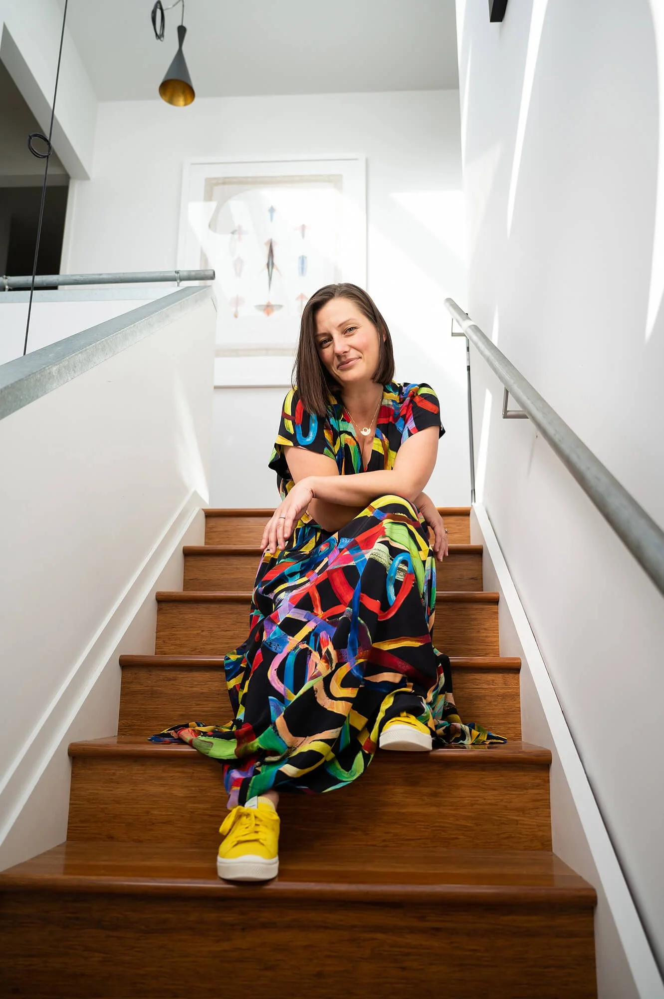 Meditation teacher sitting on stairs, smiling