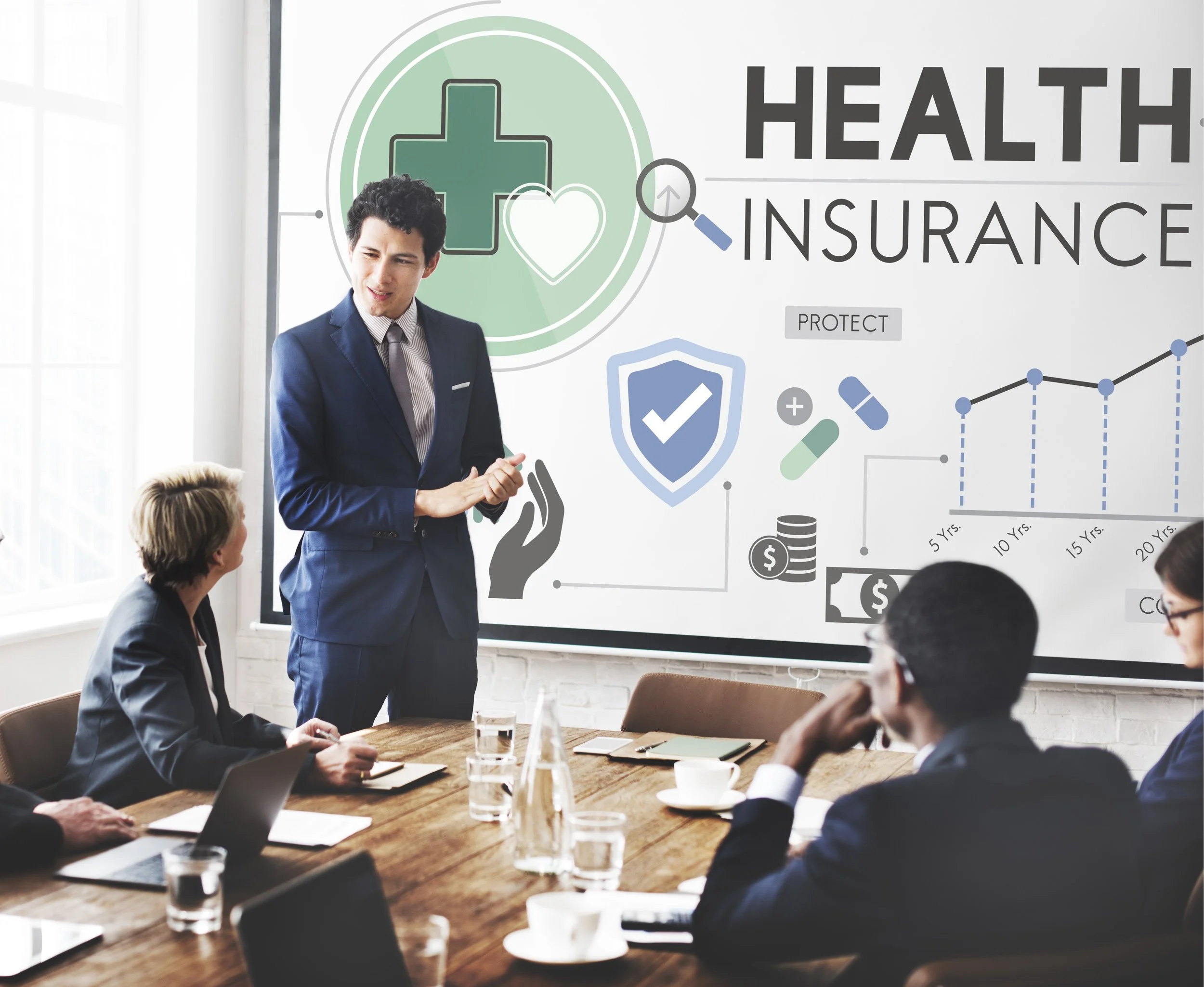 A business presentation about health insurance with a man in a suit speaking to a group of professionals in a conference room. The presentation slide displays health-related icons, graphs, and the words 'Health Insurance'.