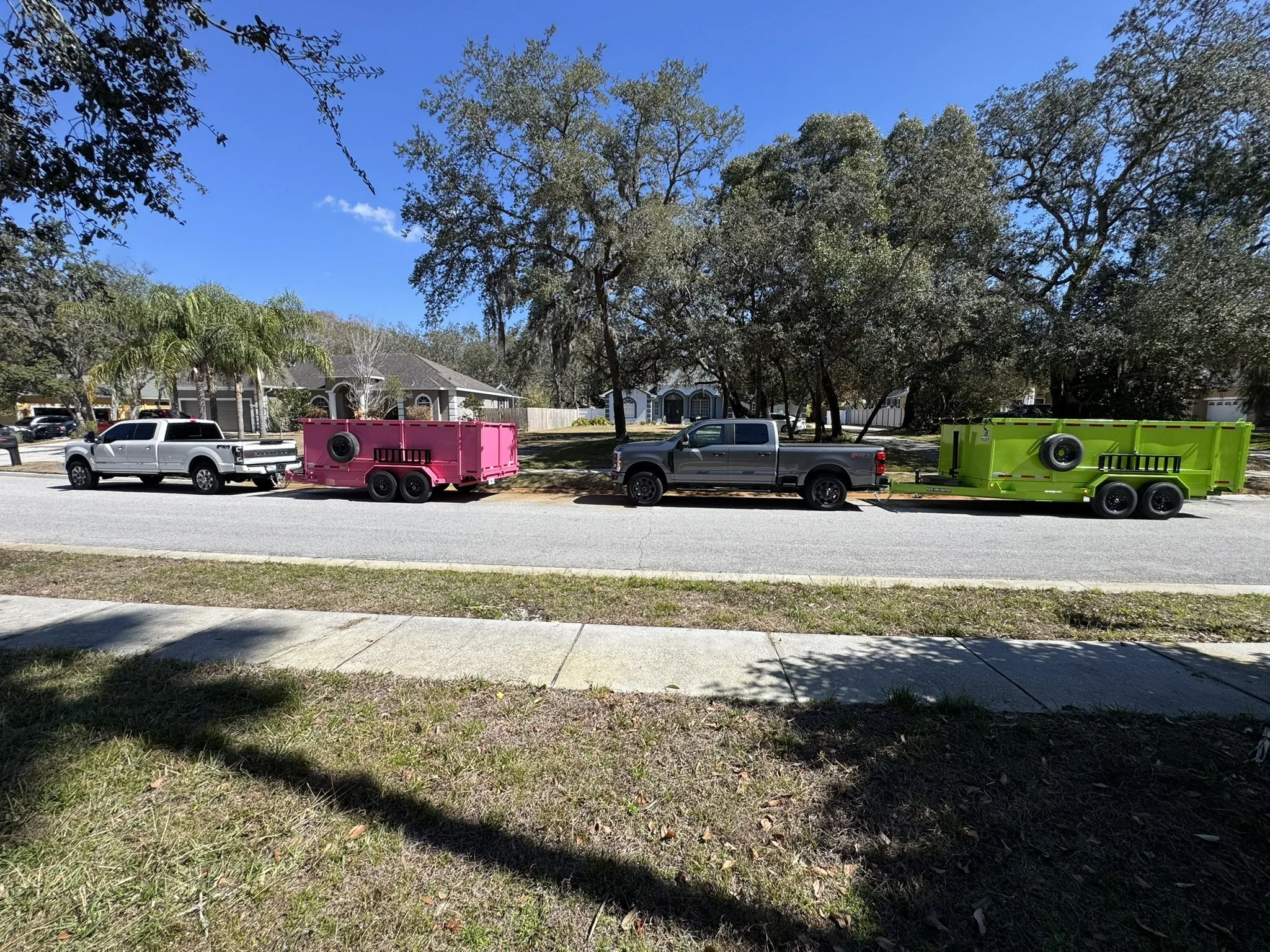 2 trucks with dump trailers
