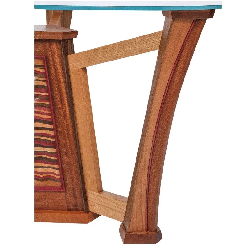 Close-up of a wooden table leg with a decorative glass top.