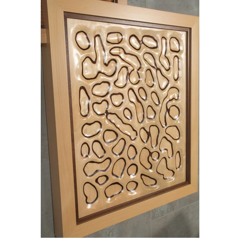 Decorative wooden panel with abstract, irregular cut-out shapes.