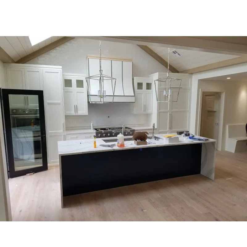 Custom contemporary kitchen with painted cabinets, modern light fixtures, and skylights.