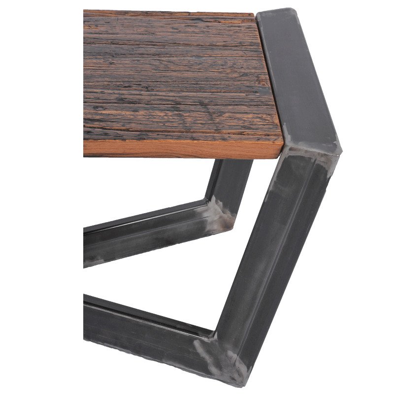Close-up of a table with a rustic wooden top and a metal frame.